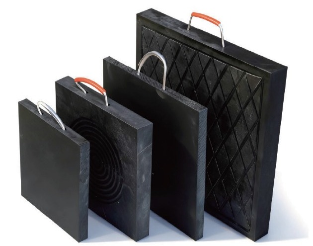 Black outrigger pads with carrying handles and smooth, circular-pattern and diamond-pattern faces